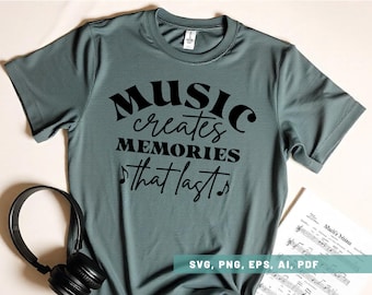 May include: A teal blue t-shirt with black text that reads "MUSIC creates MEMORIES that lasts" with musical notes on either side of the text. The shirt is laying on a white surface with a sheet of music and headphones.