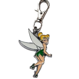 May include: A silver-colored metal keychain with a cartoon image of a fairy. The fairy has blonde hair, a green dress, and white wings. The keychain has a clasp for easy attachment to keys or bags.
