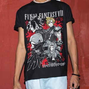 May include: Black t-shirt with a graphic print of characters from the video game Final Fantasy VII. The text "FINAL FANTASY VII" is printed in white on the shirt. The characters are depicted in a stylized, action-packed pose. The Japanese text "ファイナルファンタジー" is printed on the bottom of the shirt.