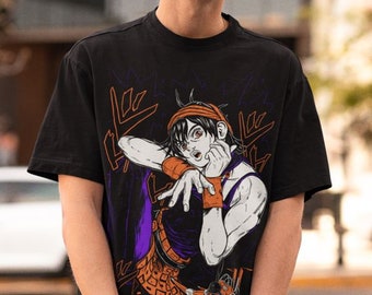 May include: A black t-shirt with a graphic print of a cartoon character with orange hair and a purple shirt. The character is holding their hand to their face and has a surprised expression. The graphic is surrounded by black and white lines.