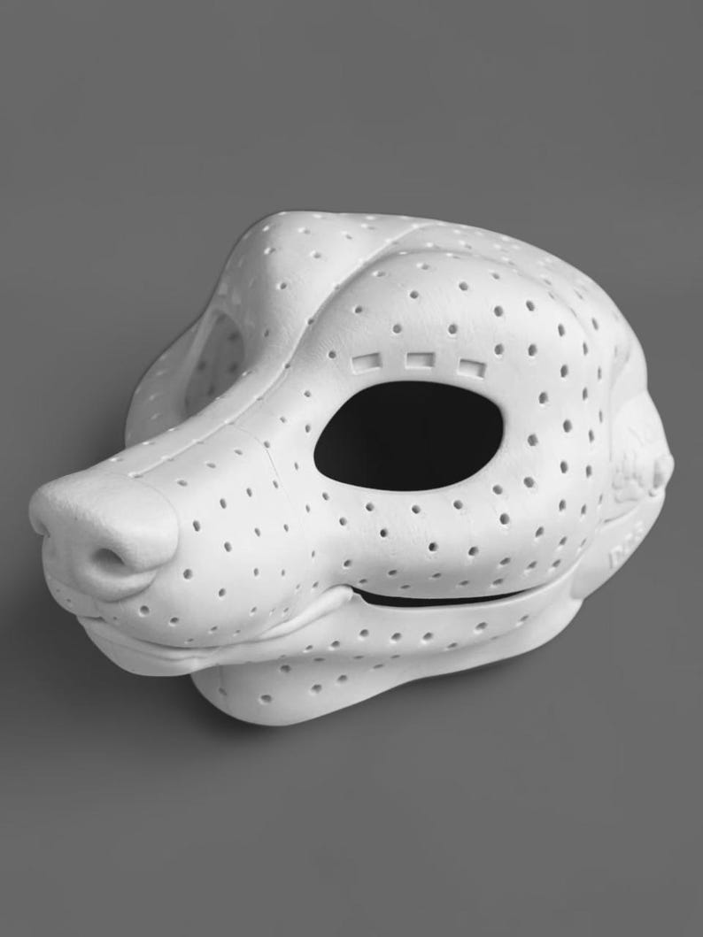 May include: A white, three-dimensional animal head mask base featuring a perforated surface texture throughout. The mask has a prominent snout, large eye openings, and a sculpted jawline, constructed from a lightweight, rigid material.