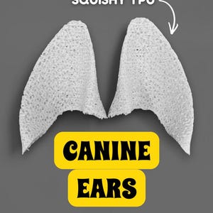 May include: Two white, textured canine ears are displayed against a gray background. The text "SQUISHY TPU" is above the ears, and the words "CANINE EARS" are in yellow rectangles below.