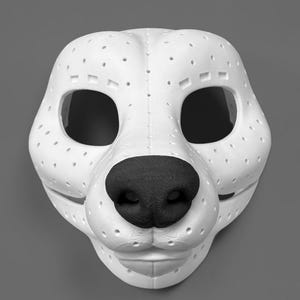 May include: A white animal-shaped mask featuring a textured black nose and numerous small ventilation holes across the surface. The mask has large eye openings and a defined snout structure, constructed with visible seams and a matte finish.