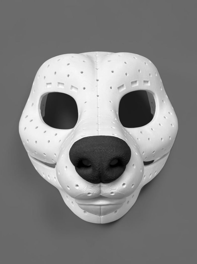 May include: A white animal-shaped mask featuring a textured black nose and numerous small ventilation holes across the surface. The mask has large eye openings and a defined snout structure, constructed with visible seams and a matte finish.