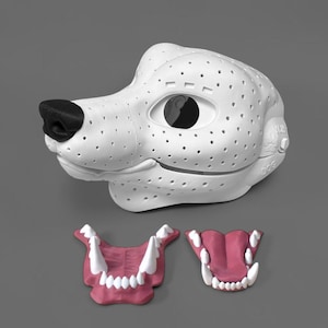 May include: A white 3D-printed dog mask base featuring a black nose and a perforated surface texture. The word DOG is embossed on the side. Two separate jaw inserts are included, each featuring pink gums and white teeth, one open and one closed.