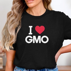 May include: Black t-shirt with a white graphic that says "I love GMO" with a red heart.