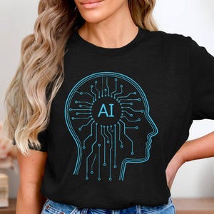 Könnte beinhalten: Schwarzes T-Shirt mit einer blauen Umrisszeichnung eines menschlichen Kopfes, der ein Leiterplattendesign enthält. Die Buchstaben "AI" befinden sich in der Mitte des Kopfes. Das Design stellt künstliche Intelligenz dar.