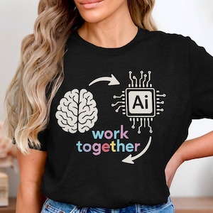 May include: Black t-shirt featuring a graphic design with a brain and a circuit board with "Ai" in the center. The words "work together" are written in colorful letters below the brain and circuit board.