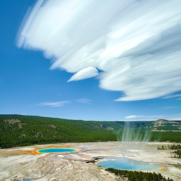 Grand prismatic spring Yellowstone National Park. This composite image is a creative way to show movement in a single frame. (Steam, clouds)