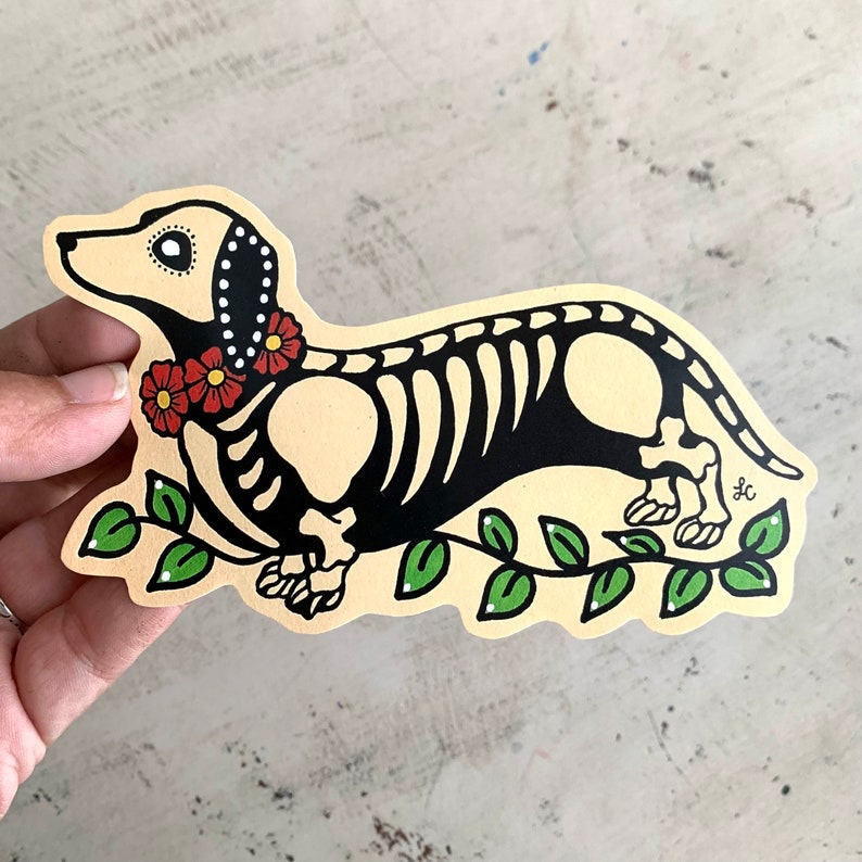May include: A black and white illustration of a dachshund skeleton wearing a red flower garland. The dachshund is walking on a green vine with leaves.