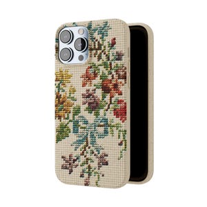 May include: A beige phone case with a floral embroidery design. The case is made of a textured material and has a cutout for the camera lens.