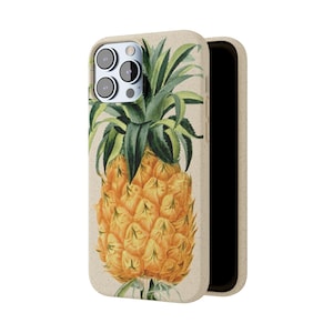 May include: A beige phone case with a pineapple design. The pineapple is yellow and green and has a detailed illustration.