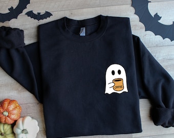 May include: Black sweatshirt with a white ghost holding a brown coffee cup that says "Coffee" on it.