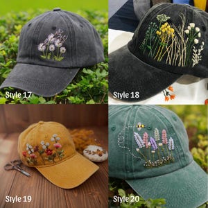 May include: Four embroidered baseball caps in different colors. The caps feature floral designs, including dandelions, wildflowers, and lavender with a bee. Each cap is labeled with a style number: 17, 18, 19, and 20. The caps are displayed on a green background.