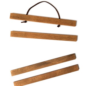 Four wooden picture hangers.