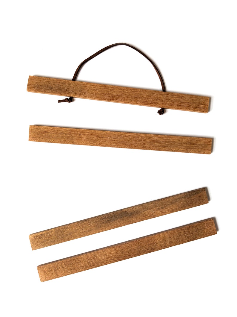 Four wooden picture hangers.