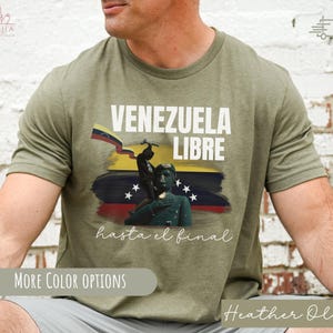 May include: A green t-shirt with a graphic print of a Venezuelan flag, a soldier, and the text "Venezuela Libre hasta el final".