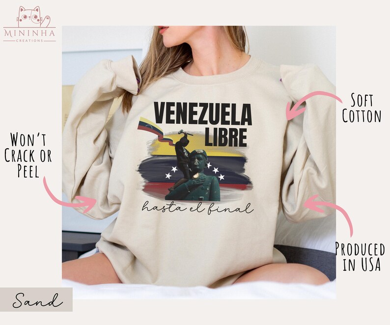 May include: A beige sweatshirt with a graphic print of a Venezuelan flag and the text "Venezuela Libre hasta el final".