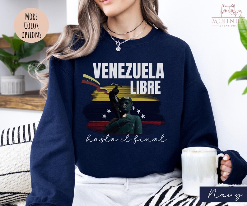 May include: Navy blue sweatshirt with a graphic of a Venezuelan flag and the text "Venezuela Libre hasta el final".