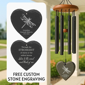 May include: A heart-shaped memorial stone with a dragonfly design and the text "Grandma Hannah Roberts 1975-2025". The image also shows a wind chime with black tubes and a wooden top, and the text "FREE CUSTOM STONE ENGRAVING".
