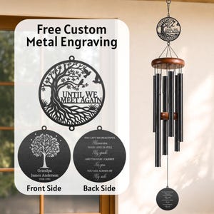 May include: A memorial wind chime featuring black metal tubes, a wooden top, and a circular metal pendant engraved with the text Until We Meet Again. The design includes a tree motif, with additional custom engraving options shown.