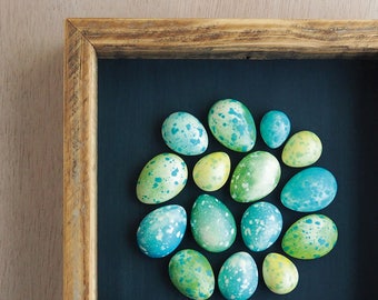 Green and blue speckled plaster egg framed wall art: handmade in Australia by Emily Engel