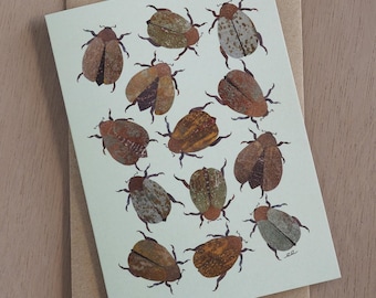 Christmas beetle blank greeting card with art designed by Emily Engel using monoprint collage