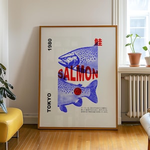 Peut inclure: Une affiche vintage avec une illustration bleue et blanche de deux saumons. L'affiche porte le texte "TOKYO 1980 SALMON 鮭" en rouge et noir.