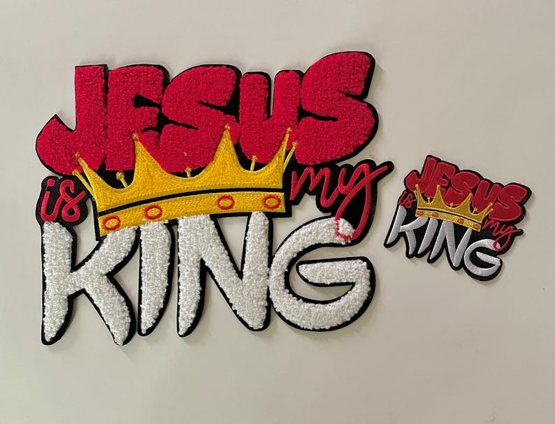 May include: Embroidered patch set with the words "Jesus is my King" in red, white, and black. The design includes a gold crown. A smaller version of the design is also included.