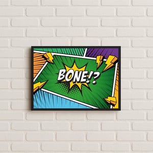 May include: A framed comic book art print with the word "BONE!?" in a yellow burst, surrounded by green, orange, blue, and purple panels. Yellow lightning bolts accent the design, set against a white brick wall.
