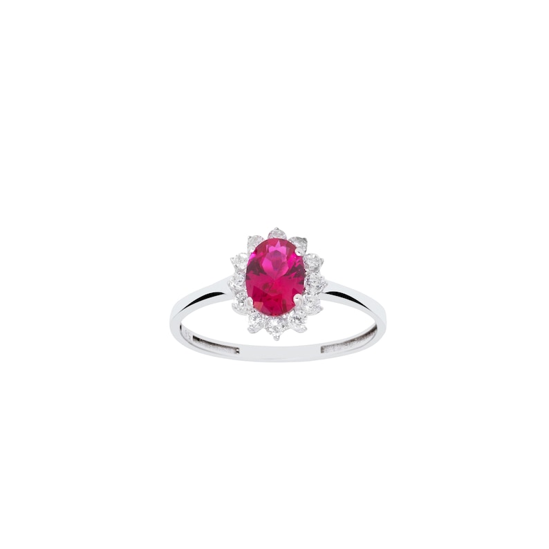 May include: A silver ring with a large oval-shaped red gemstone surrounded by smaller white gemstones.