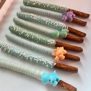 Dinosaur Pretzel Rods, Pastel Dinosaur Birthday Treats, Dinosaur Dessert Table Treats, Dino Pretzels, Dino Chocolate