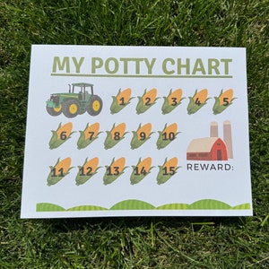 May include: A green and yellow tractor with a white background. The tractor is on a potty chart with 15 corn cobs numbered 1-15. The chart says "My Potty Chart" and "Reward:" at the bottom.
