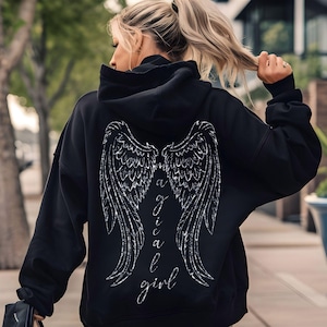 May include: Black hoodie with a white graphic of angel wings and the word "magical girl" on the back.