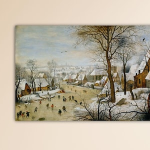 May include: A framed print of a winter landscape scene. The artwork depicts a village with snow-covered rooftops, leafless trees, and figures ice skating on a frozen body of water. The sky is overcast, and the overall color palette is muted.