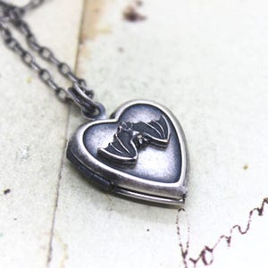 bat. heart locket necklace. downward facing bat silver ox jewelry with a silver ox bat or a silver tone bat