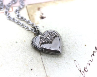 bat. locket necklace. in antiqued shiny silver tone inset heart