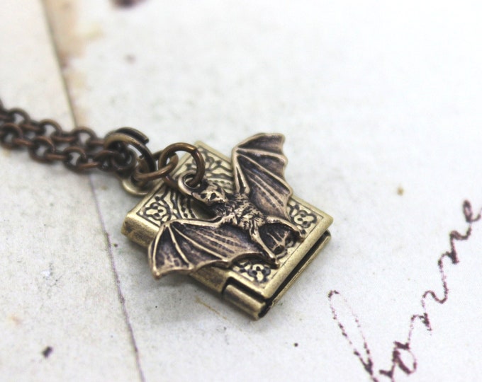 bat. locket necklace. in brass ox little book locket