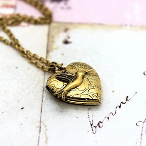 hummingbird. locket necklace. gold ox with tapestry pattern heart