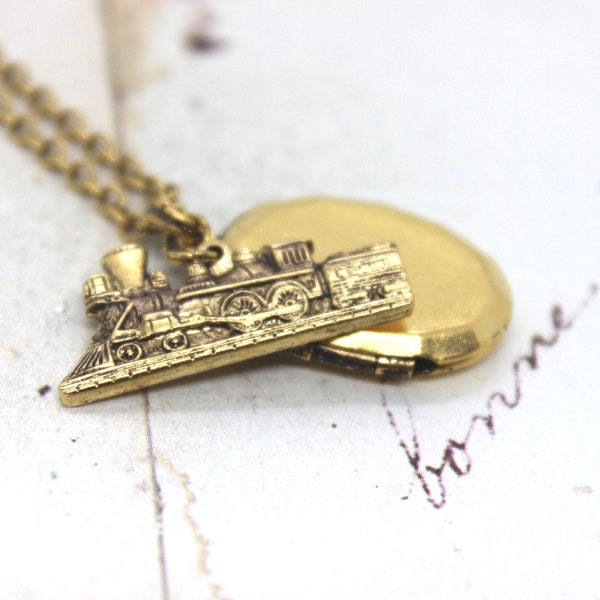 locomotive. locket necklace. gold ox train