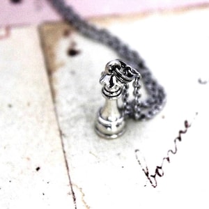chess piece necklace. silver tone