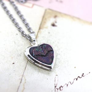 bat. locket necklace. in white plate shiny silver tone inset heart