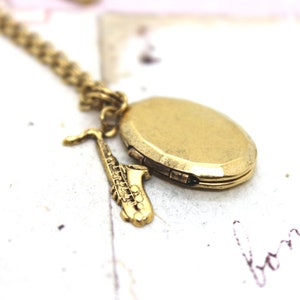 saxophone. heart locket necklace. in gold ox with etched lines locket