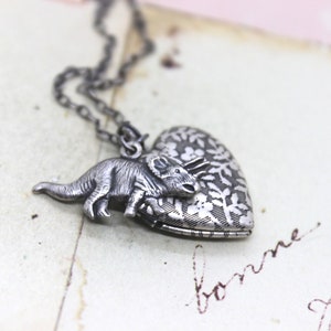 triceratop. heart locket necklace. in silver ox with floral locket dinosaur