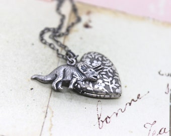 triceratop. heart locket necklace. in silver ox with floral locket dinosaur