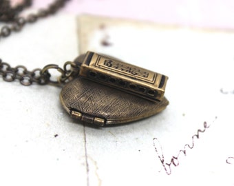 harmonica. heart locket necklace. in brass ox with etched lines locket