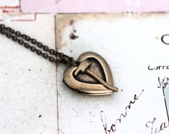 axe. heart locket necklace. in brass ox jewelry