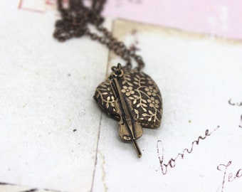 violin. heart locket necklace. in brass ox with floral pattern