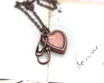 stethoscope. heart locket necklace. copper ox