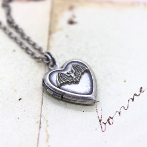 bat. heart locket necklace. silver ox jewelry with a silver tone bat or a silver ox bat